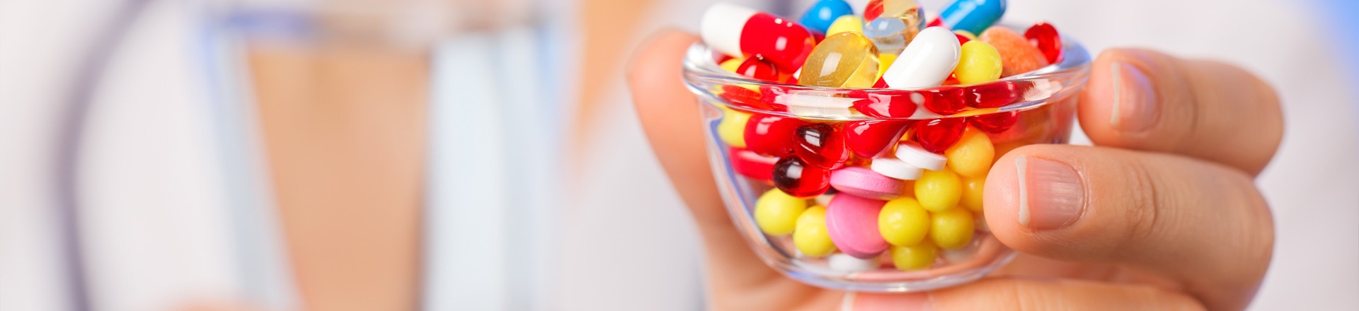 polypharmacy and the polypill - too many medications symbolized by a bowlful of pills