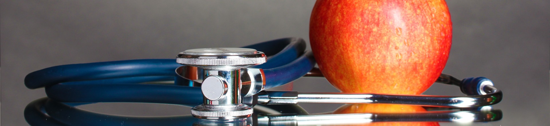 stethoscope with a red apple