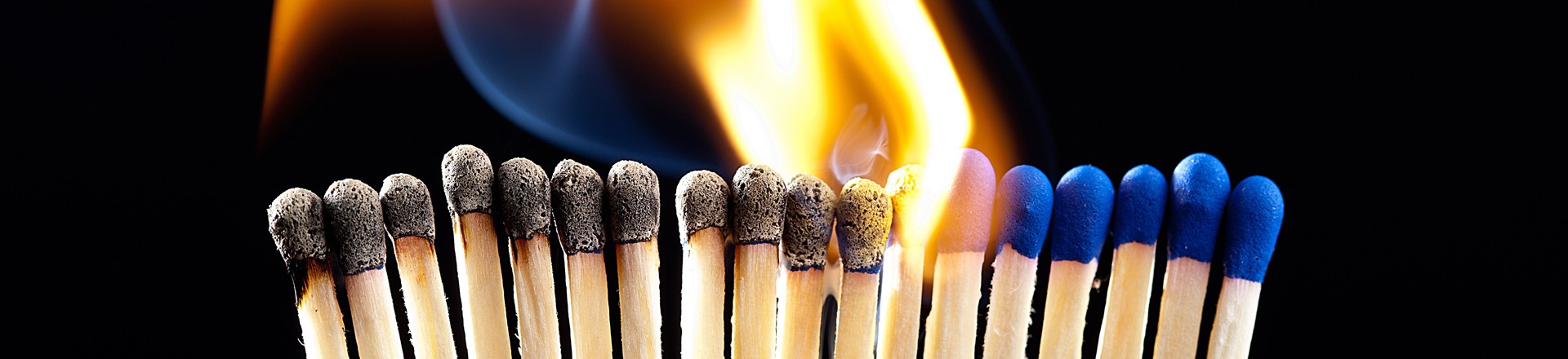 a row of lit match sticks represent chronic inflammation in the body