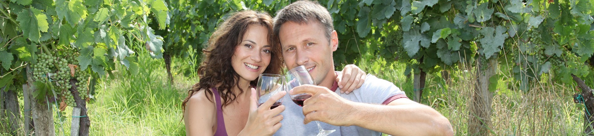 man and woman picnicking drinking wine